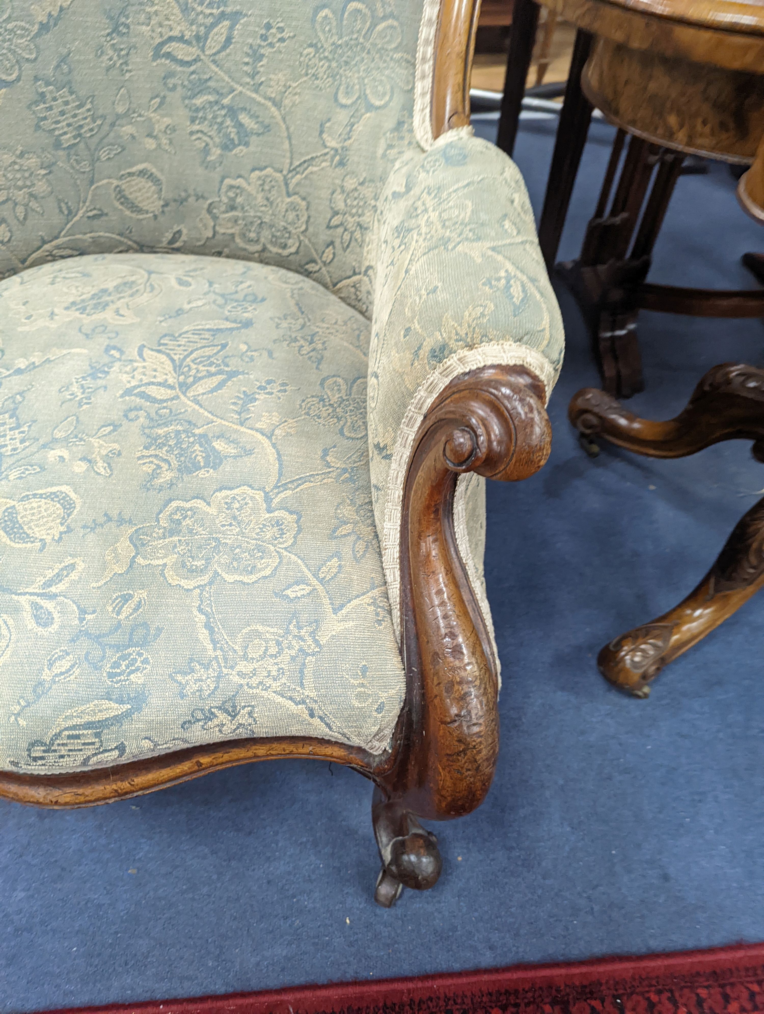 An upholstered Victorian armchair